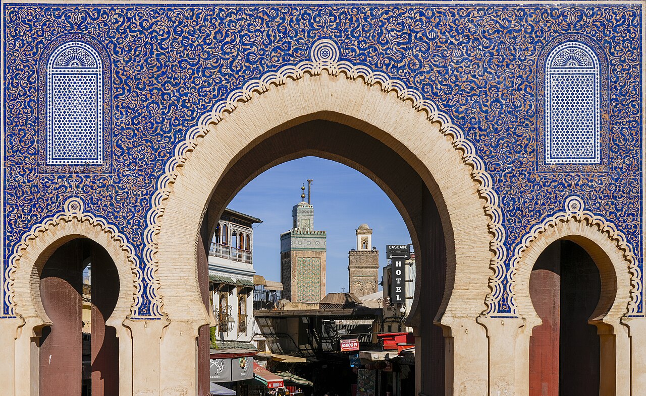 Minarets framed by the blue-tiled Bab Bou Jeloud gate at the entrance to the Fes medina