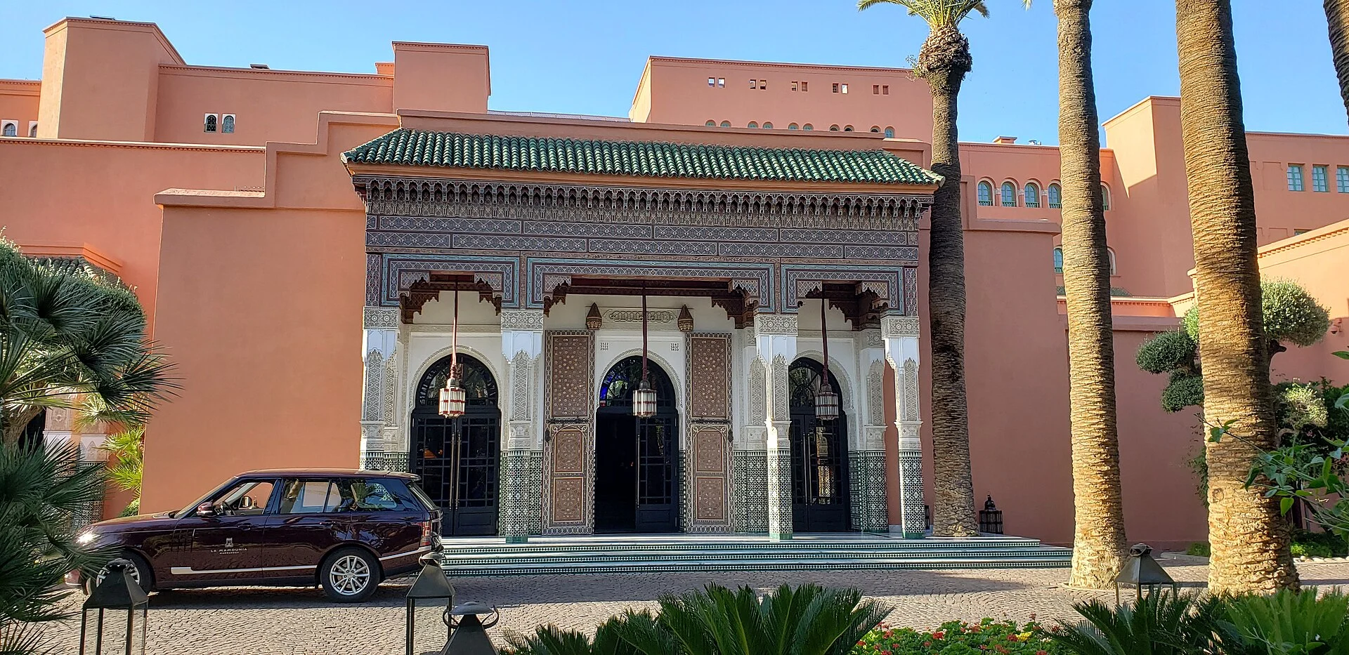 The entrance to La Mamounia in Marrakech, with Moroccan tilework and palm trees