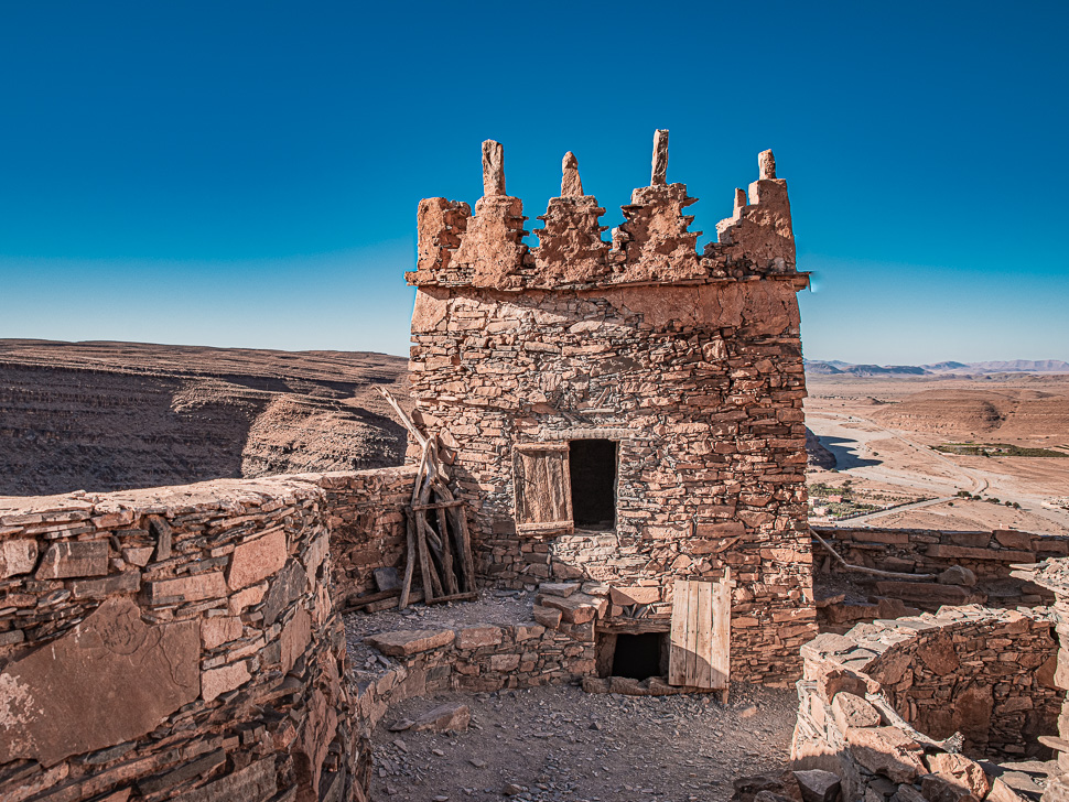 Crenellated stone towers of an Anti-Atlas granary overlooking a dry, open landscape