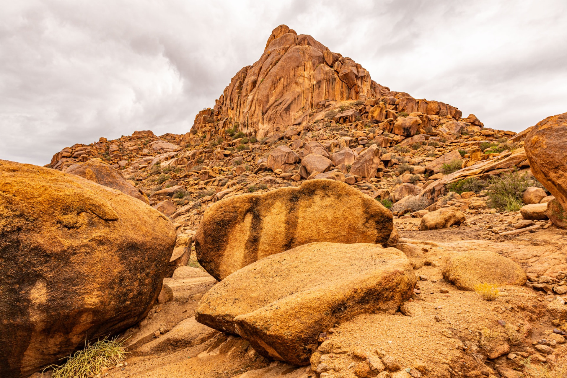 Huge rounded granite boulders scattered across an arid landscape near Tafraoute