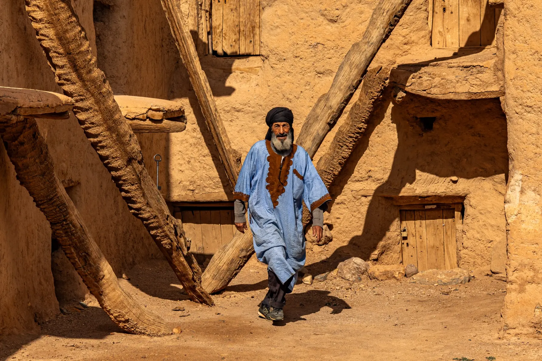 A local man walking through the courtyard of Aït Kine Granary near Tata